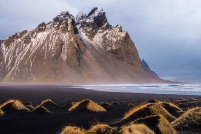 Scenic view of mountains against cloudy sky