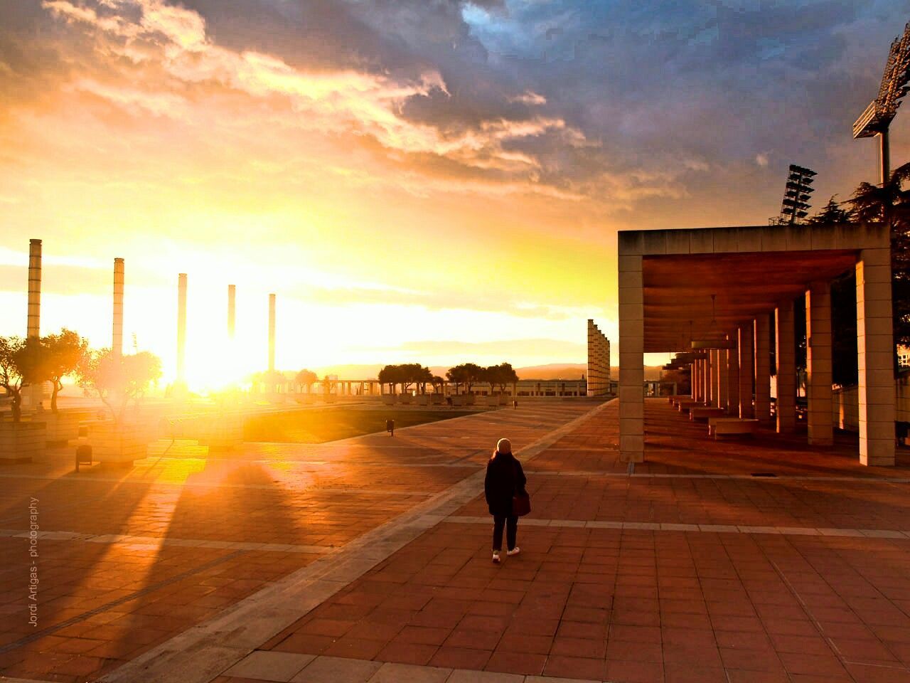 sunset, full length, rear view, walking, one person, built structure, people, vacations, outdoors, business finance and industry, real people, city, architecture, one woman only, adult, adults only, sky, day