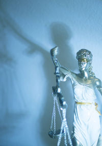 Close-up of lady justice against wall