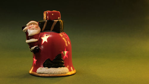 Close-up of figurine on table against gray background