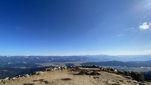 Panoramic view of landscape and mountains against blue sky