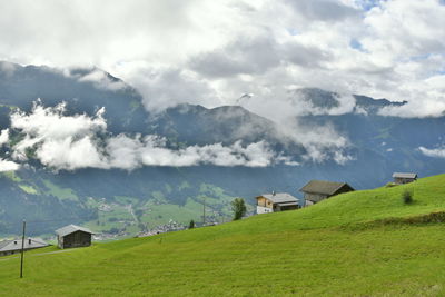 Scenic view of landscape and houses against sky