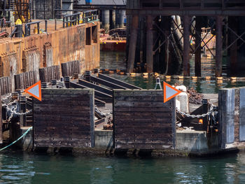 Boats in canal by buildings in city