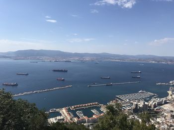 High angle view of city by sea against sky