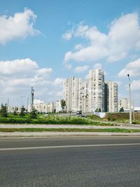 View of cityscape against cloudy sky