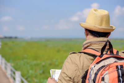 Rear view of man looking at field