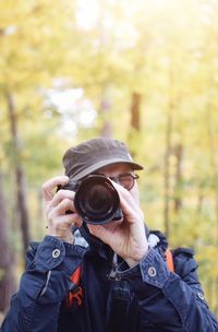 Man photographing in forest