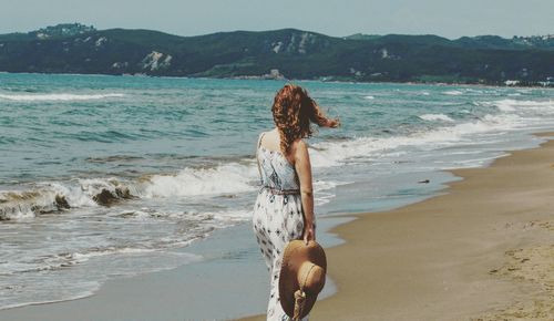 Rear view of woman at beach