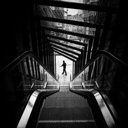 Rear view of silhouette man standing on staircase