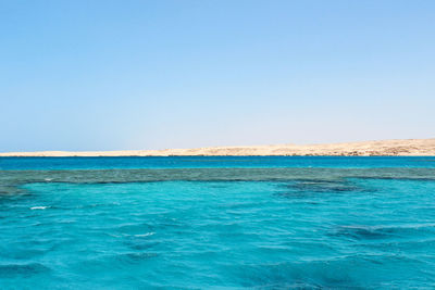 Scenic view of sea against clear blue sky