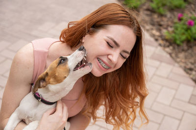 Young woman with dogs on footpath