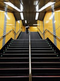 Man walking on staircase in subway