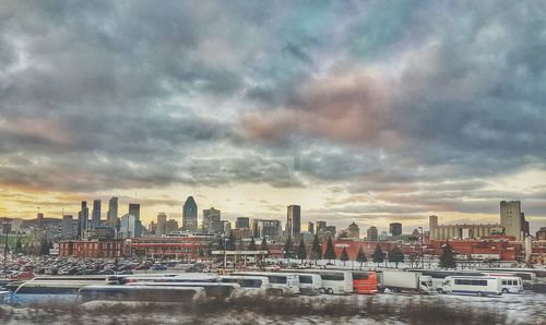 View of cityscape against cloudy sky during sunset