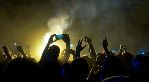 Group of people photographing at music concert