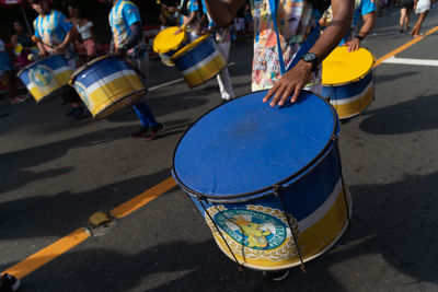 Midsection of man playing drum