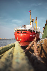 Ship moored on sea against sky