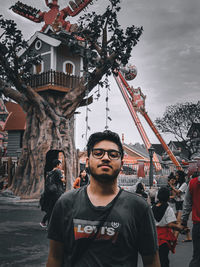 Portrait of man standing against built structure