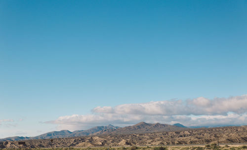 Scenic view of mountains against clear blue sky