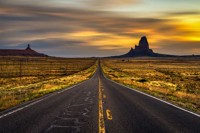 Road amidst landscape against sky during sunset