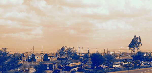 Electricity pylon against cloudy sky