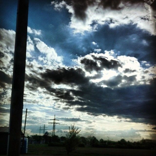 sky, cloud - sky, fuel and power generation, cloudy, silhouette, electricity pylon, tranquility, cloud, technology, landscape, tranquil scene, wind turbine, field, nature, electricity, beauty in nature, scenics, low angle view, sunset, alternative energy