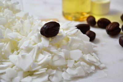 Close-up of jojoba seeds and flakes on table