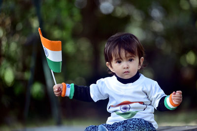 Portrait of cute baby holding indian flag