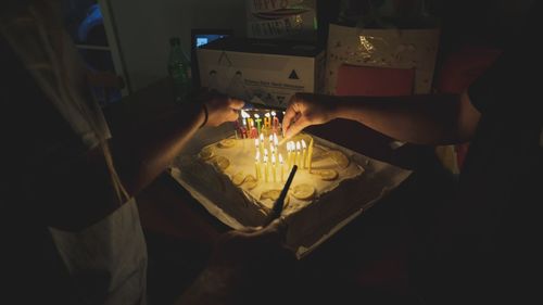 Midsection of woman holding wine in glass
