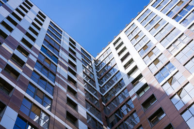 Facades of high-rise buildings against a blue sky