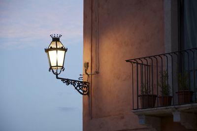 Low angle view of street light against building