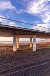 Bridge over beach against sky