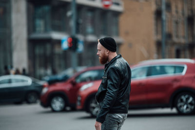 Side view of man walking on city street