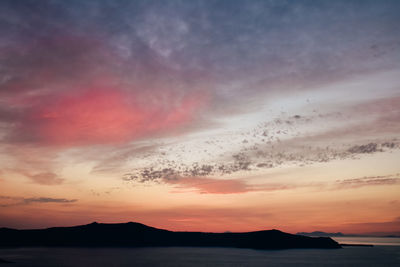 Scenic view of sea against romantic sky at sunset