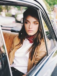 Portrait of woman sitting in car