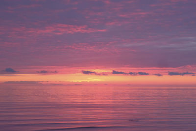 Scenic view of sea against romantic sky at sunset