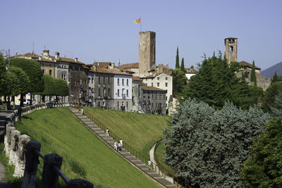 Buildings in city against clear sky