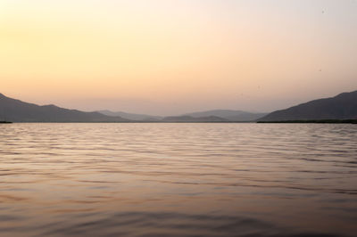 Scenic view of lake against sky during sunset