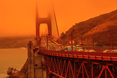 View of suspension bridge against sky during sunset