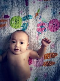 Portrait of cute baby girl on bed