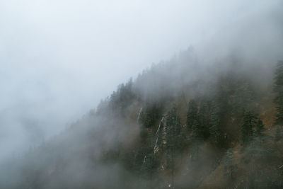 Scenic view of mountains against sky during foggy weather