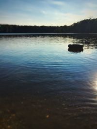 Scenic view of lake against sky at sunset