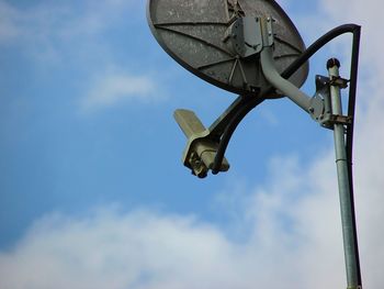 Low angle view of metal equipment against sky