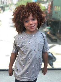 Portrait of smiling boy standing outdoors