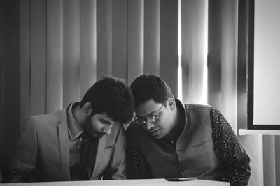 Young couple sitting on table
