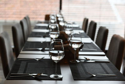 Wineglasses with place setting on dining table