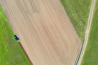 High angle view of tire tracks on field