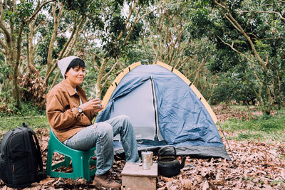 Portrait of man sitting in tent