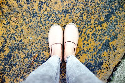 Low section of woman standing on footpath