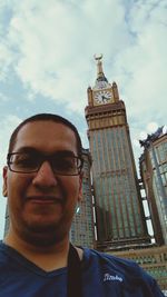 Portrait of man against sky in city