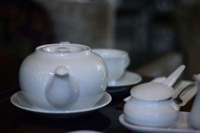 Close-up of porcelain utensils on table